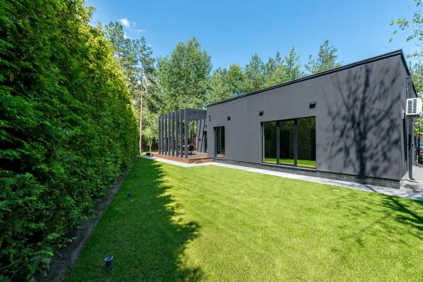 Modern home with a lush green artificial grass lawn
